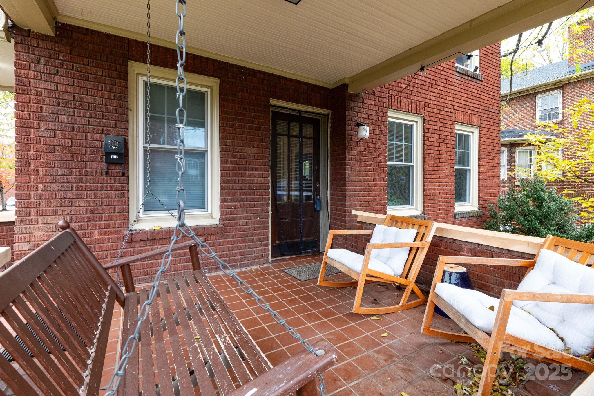 16 Gracelyn Road Asheville, NC 28804 - Photo 3 of 22 a balcony with furniture and wooden floor