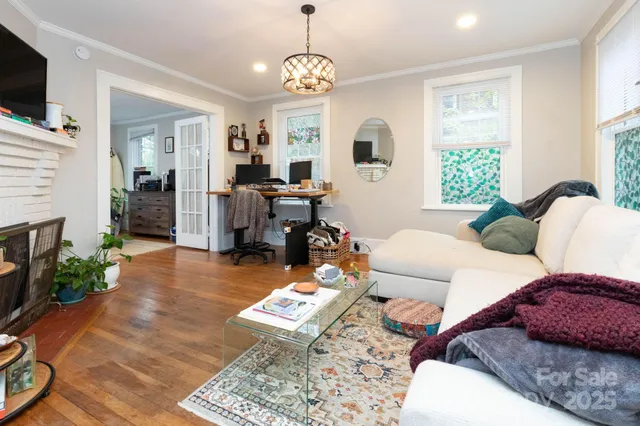 a living room with furniture a window and a flat screen tv