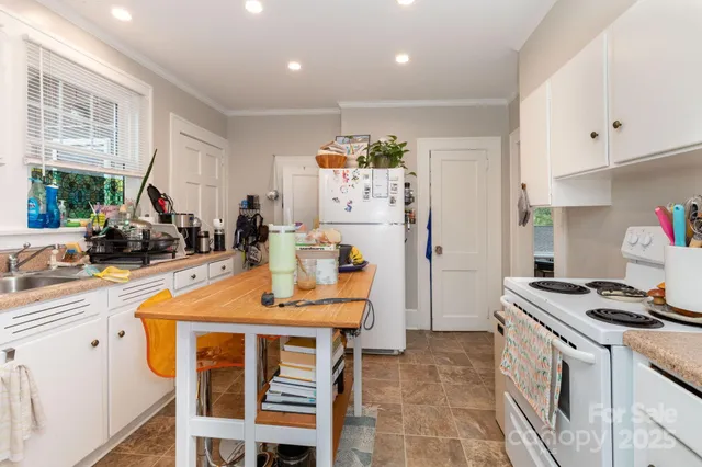 a kitchen that has a table and chairs in it