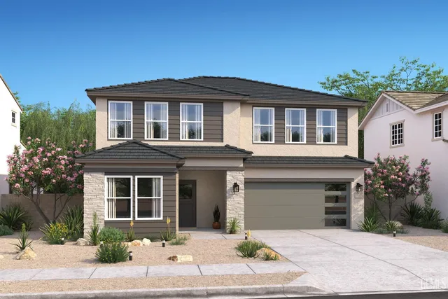 a front view of a house with a yard and a garage