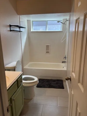 a bathroom with a sink a toilet and a shower