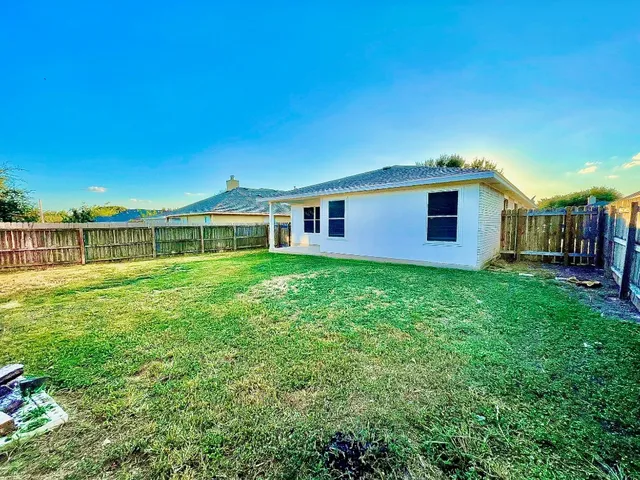 a view of a house with a back yard
