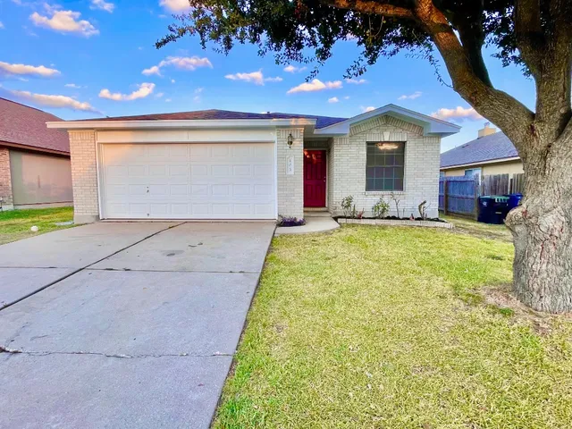 a view of a house with a yard and garage