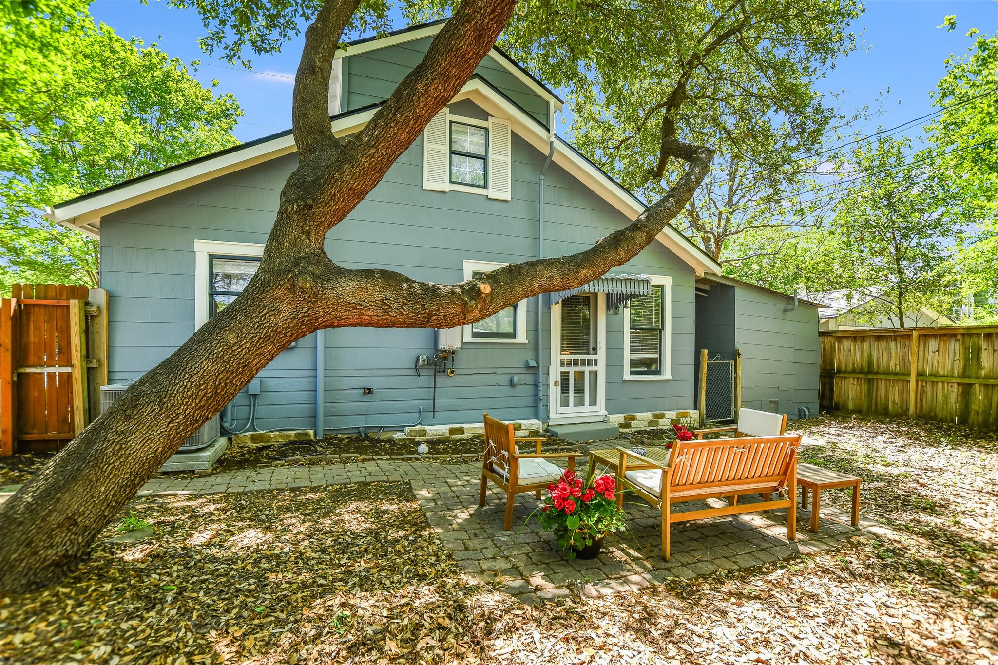1105 West 43rd Street Austin, TX 78756 - Photo 2 of 22 a backyard of a house with table and chairs
