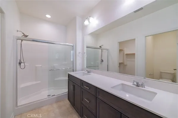 a spacious bathroom with a shower sink vanity and mirror