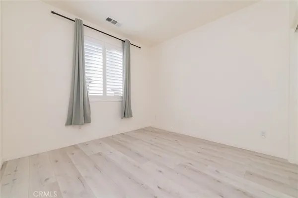 an empty room with wooden floor
