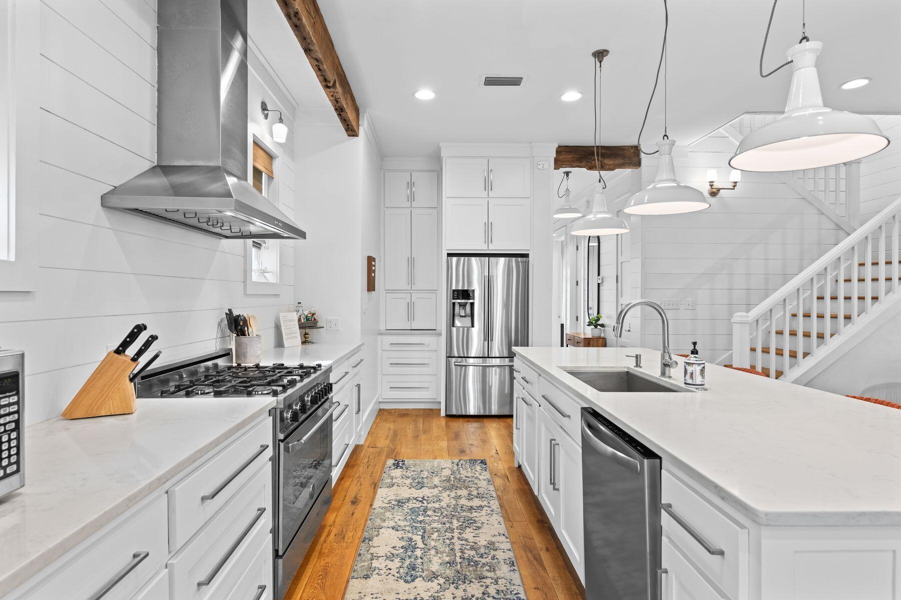 75 Lifeguard Loop West Seacrest, FL 32461 - Photo 6 of 37 a kitchen with stainless steel appliances granite countertop a sink a stove and a wooden floors