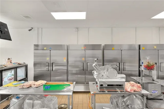 a kitchen that has a lot of cabinets and a refrigerator