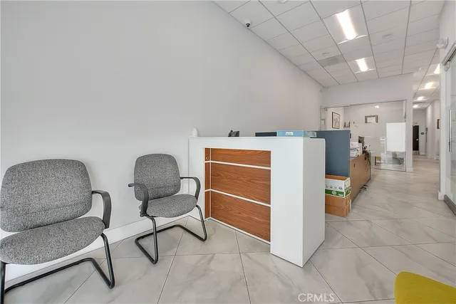 a living room with a couch and a dining table with projector
