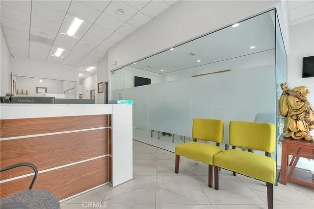 a hallway with a dining table and a chandelier