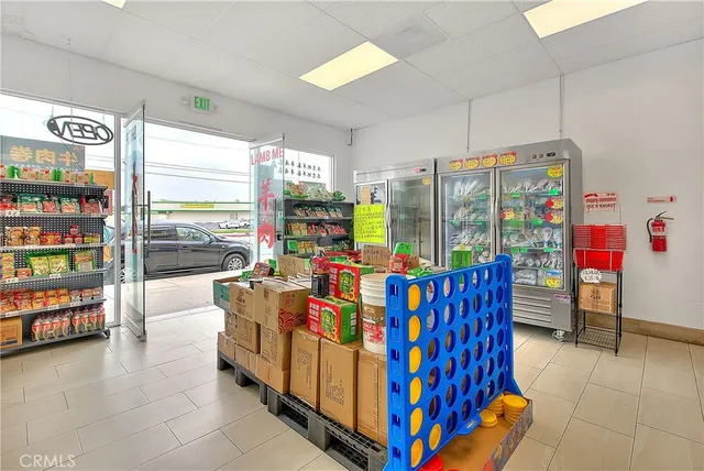 a living room with furniture and a book shelf