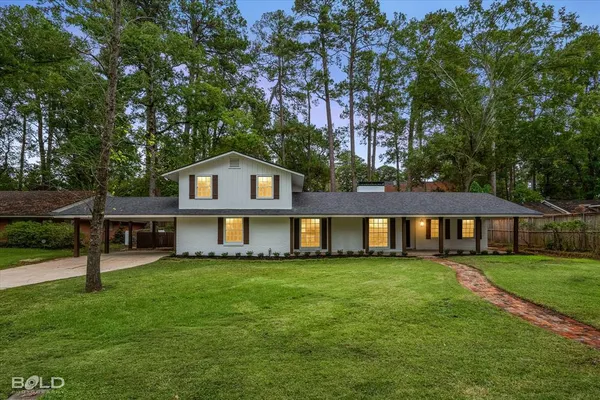 a front view of a house with a garden