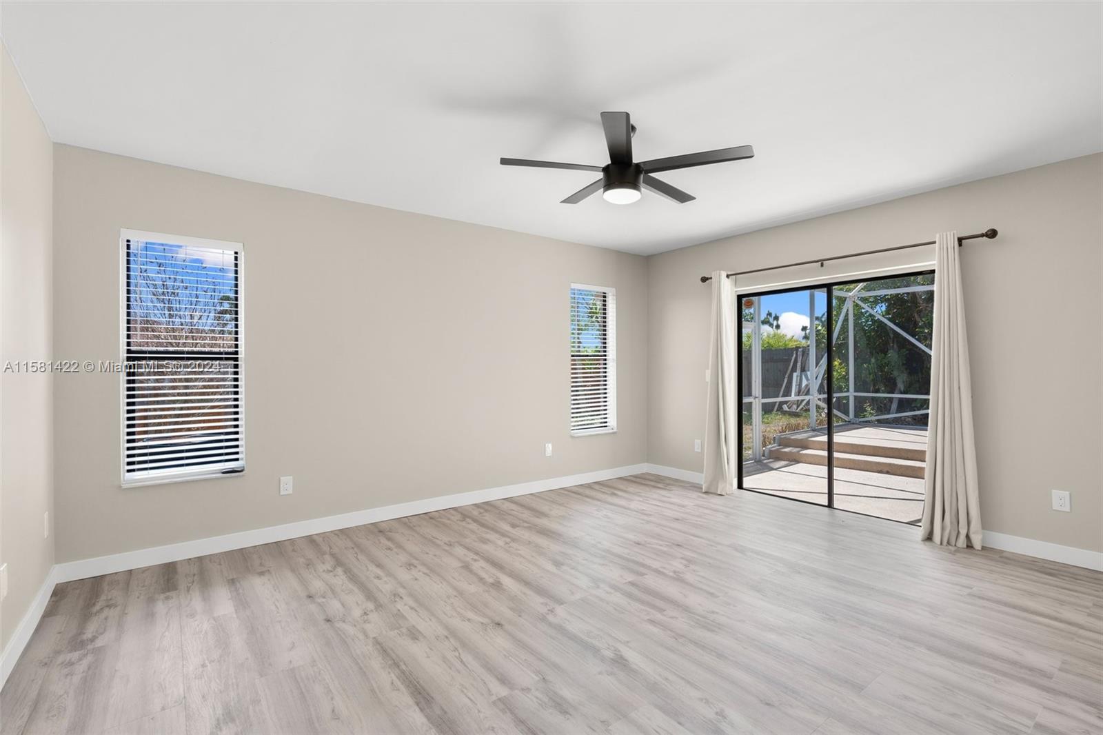 17689 Woodview Terrace Boca Raton, FL 33487 - Photo 12 of 15 a view of empty room with wooden floor and fan