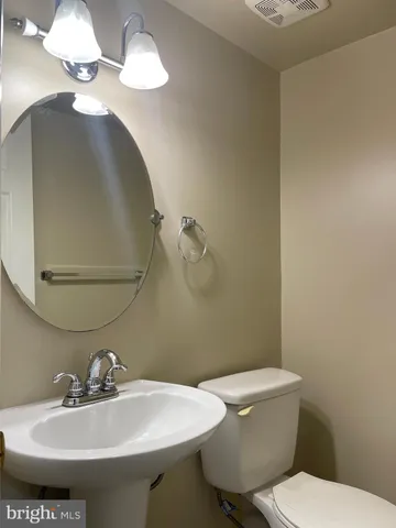 a bathroom with a sink a mirror and a toilet