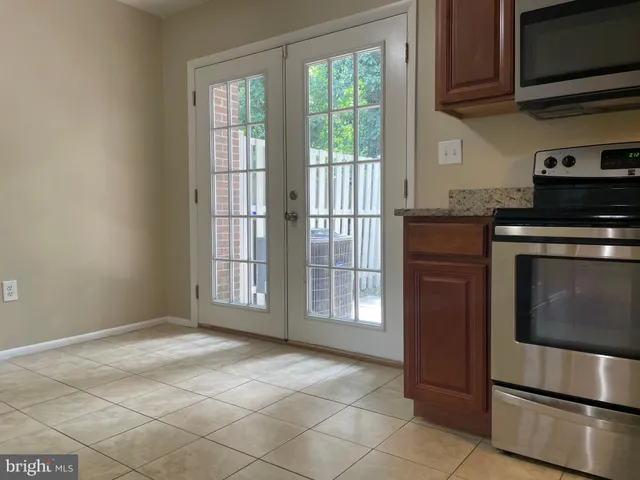 a kitchen with a stove top oven and cabinets