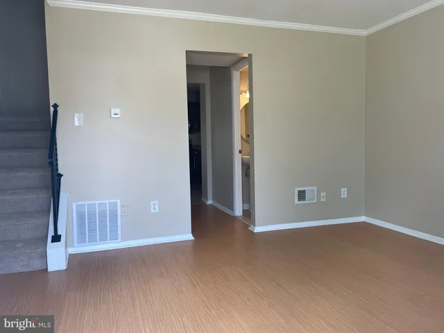 an empty room with closet and windows