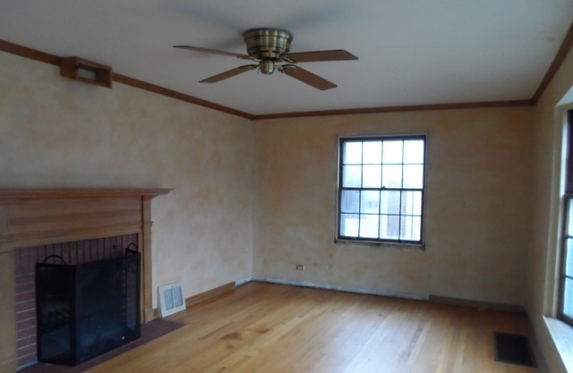1446 Linden Road Homewood, IL 60430 - Photo 2 of 12 an empty room with wooden floor a ceiling fan and windows