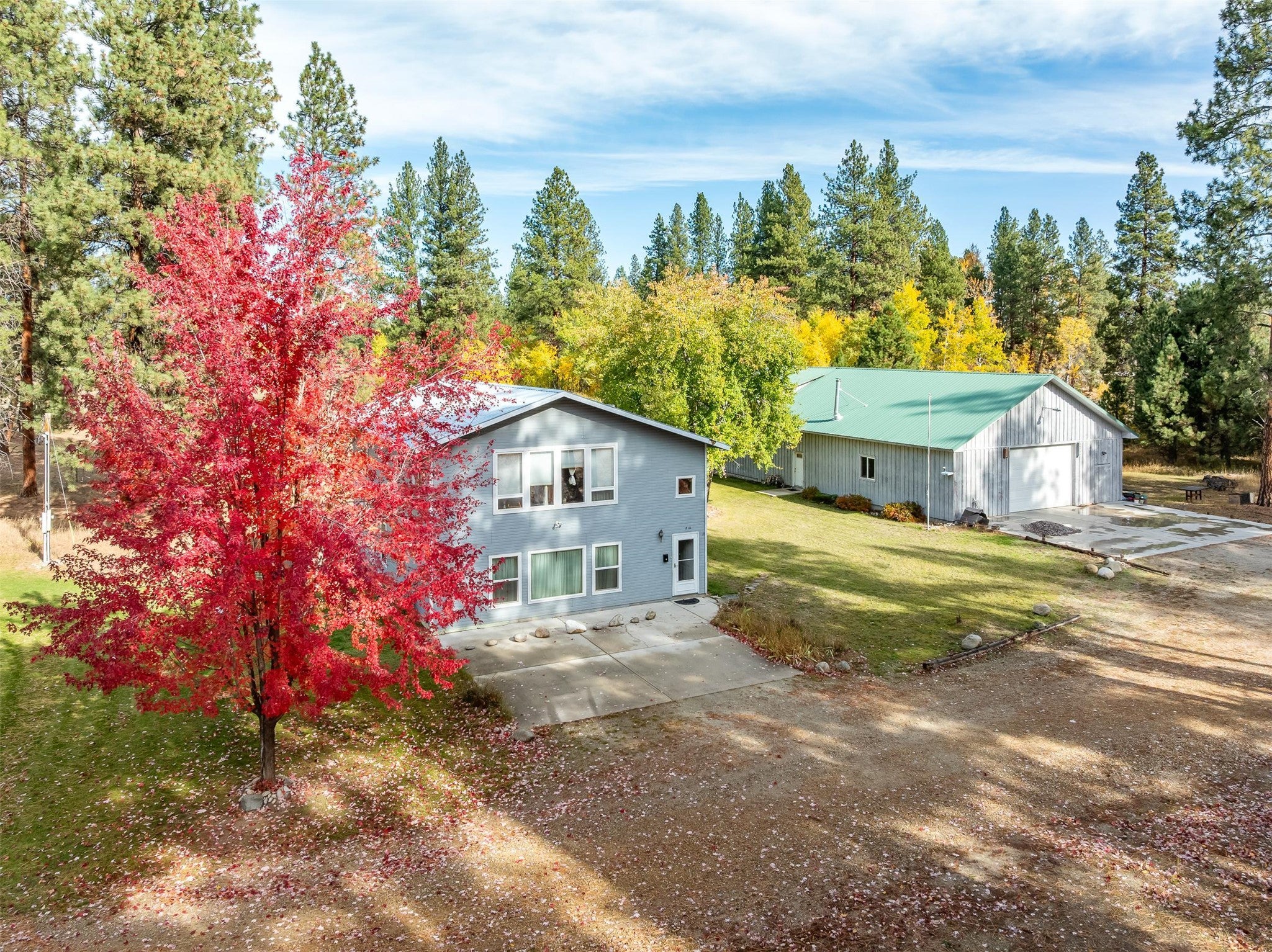 212 St Marys Road Stevensville, MT 59870 - Photo 10 of 39 Back of property featuring a yard, an outbuilding, and a patio