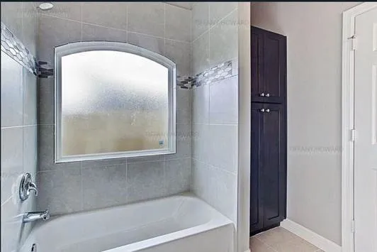 a bath tub sitting next to a window