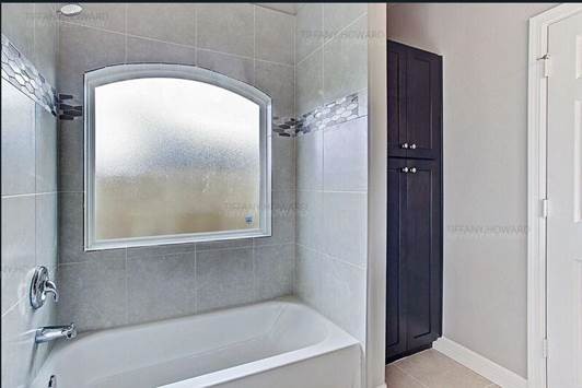 4204 Stassen Street, Unit B Houston, TX 77051 - Photo 4 of 11 a bath tub sitting next to a window