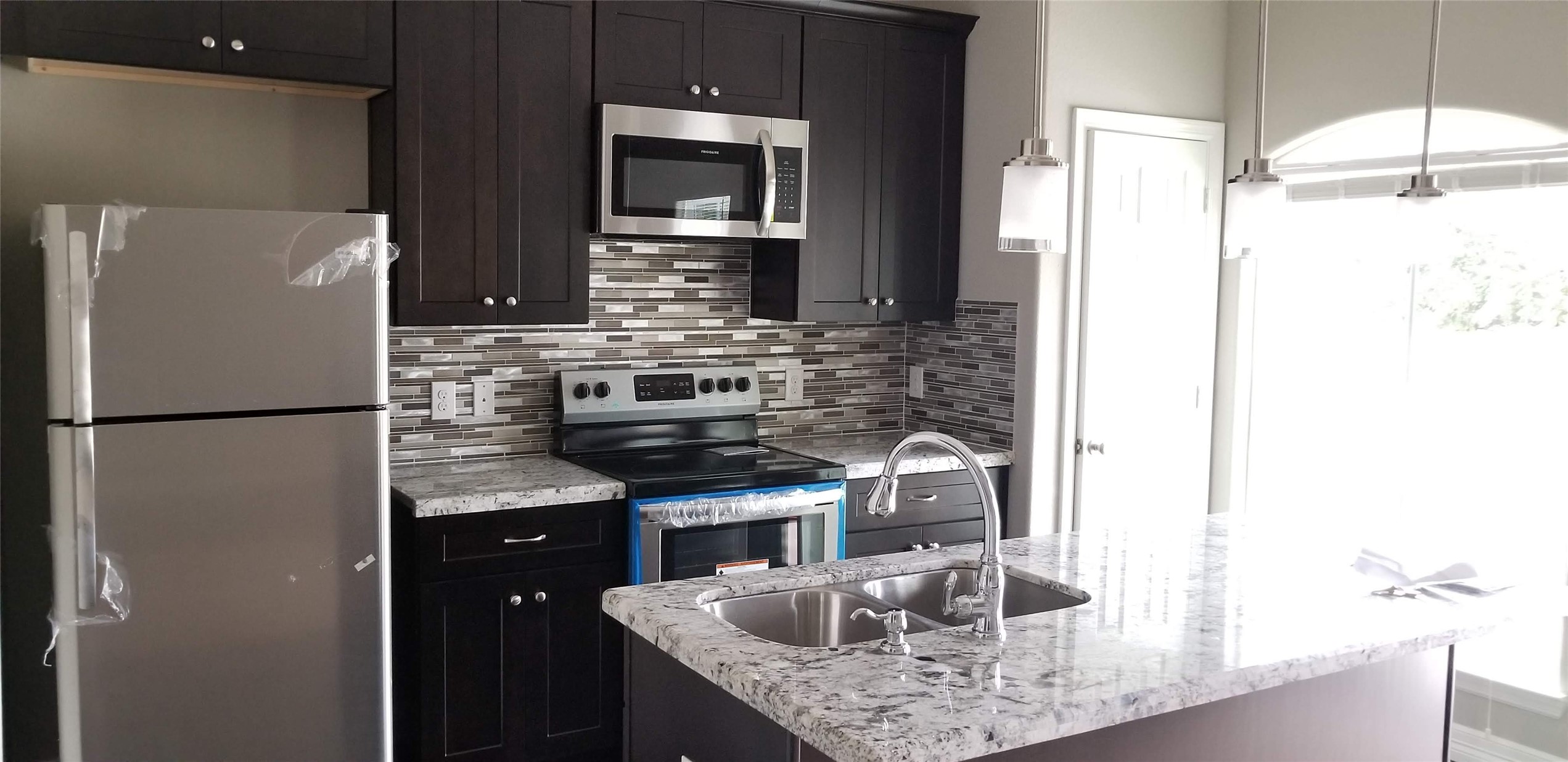 4204 Stassen Street, Unit B Houston, TX 77051 - Photo 9 of 11 a kitchen with stainless steel appliances granite countertop a refrigerator and a sink