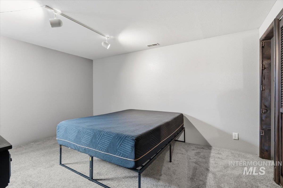 7771 Elmore Road Fruitland, ID 83619 - Photo 26 of 48 Bedroom featuring carpet and track lighting