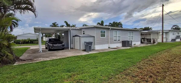 a view of swimming pool with outdoor seating and yard in back