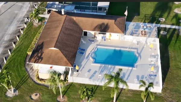 a view of a house with a yard and front view