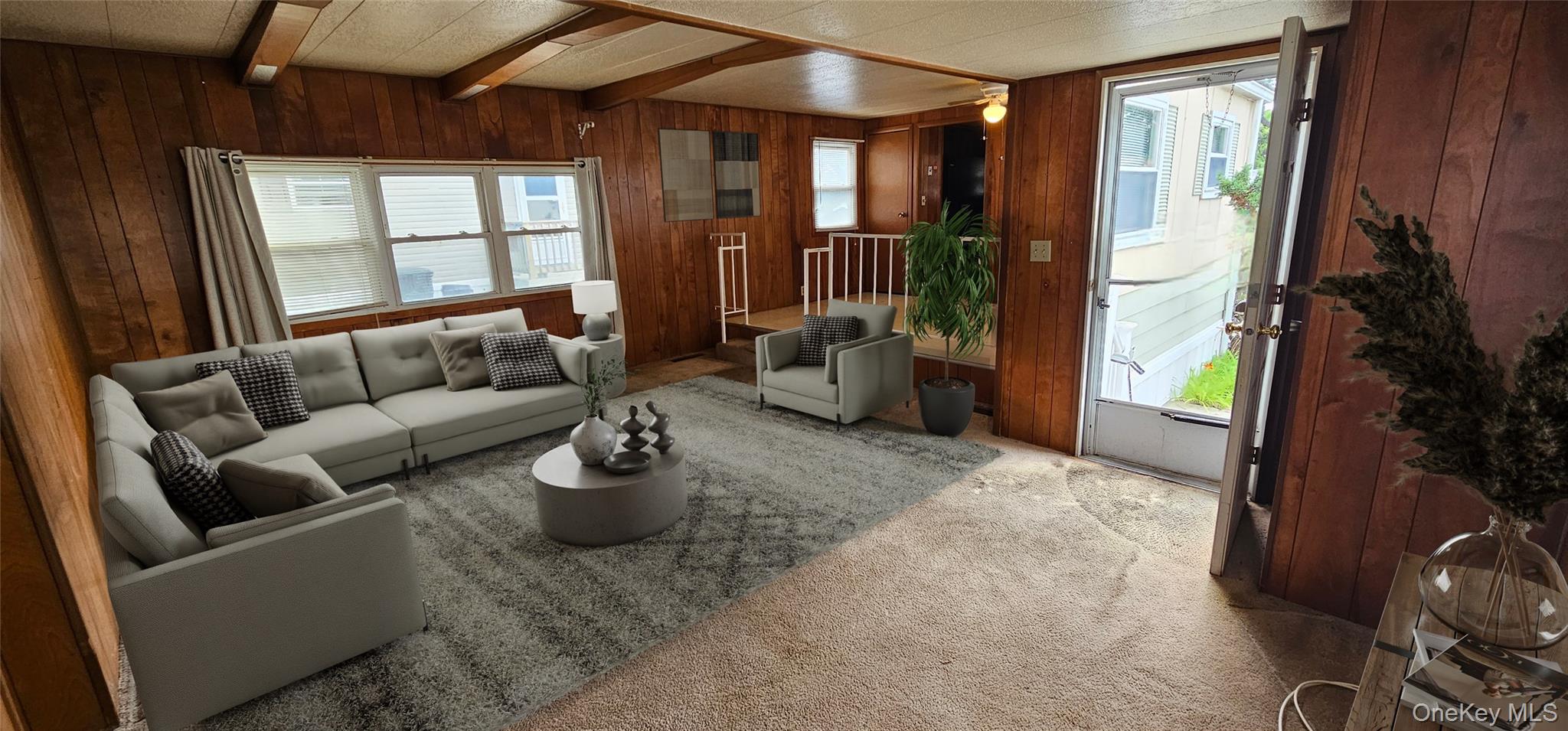 1964 River Road, Unit 37 Calverton, NY 11933 - Photo 3 of 13 a living room with furniture and a large window