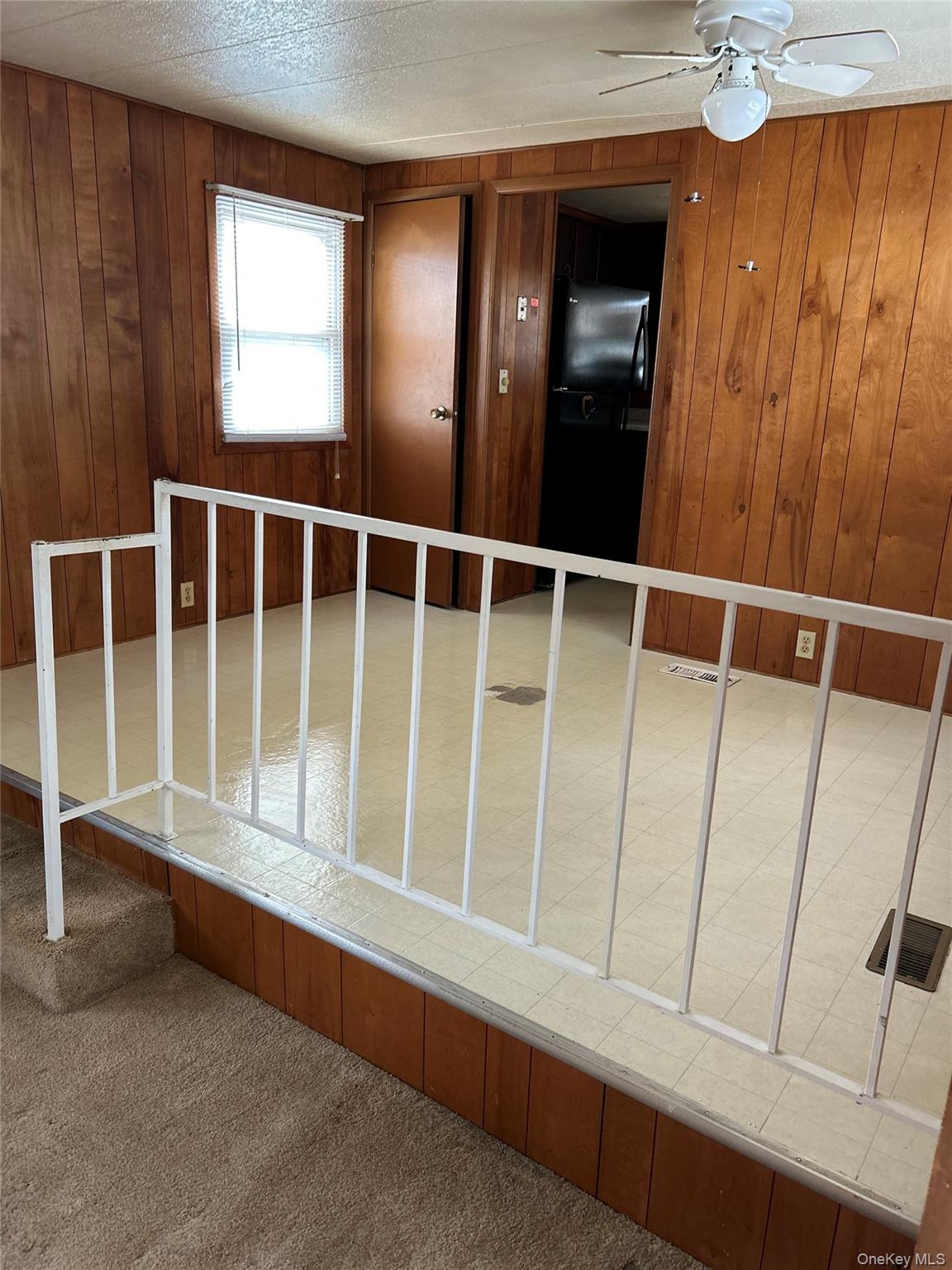 1964 River Road, Unit 37 Calverton, NY 11933 - Photo 6 of 13 a view of an empty room with a window