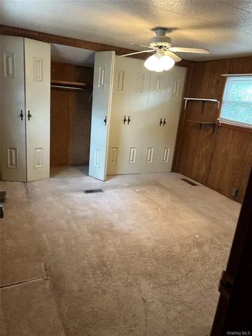 a view of an empty room with wooden door