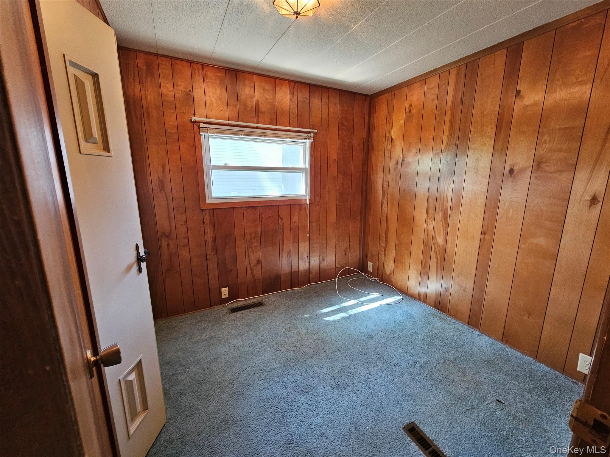 1964 River Road, Unit 37 Calverton, NY 11933 - Photo 8 of 13 a view of an empty room with wooden door