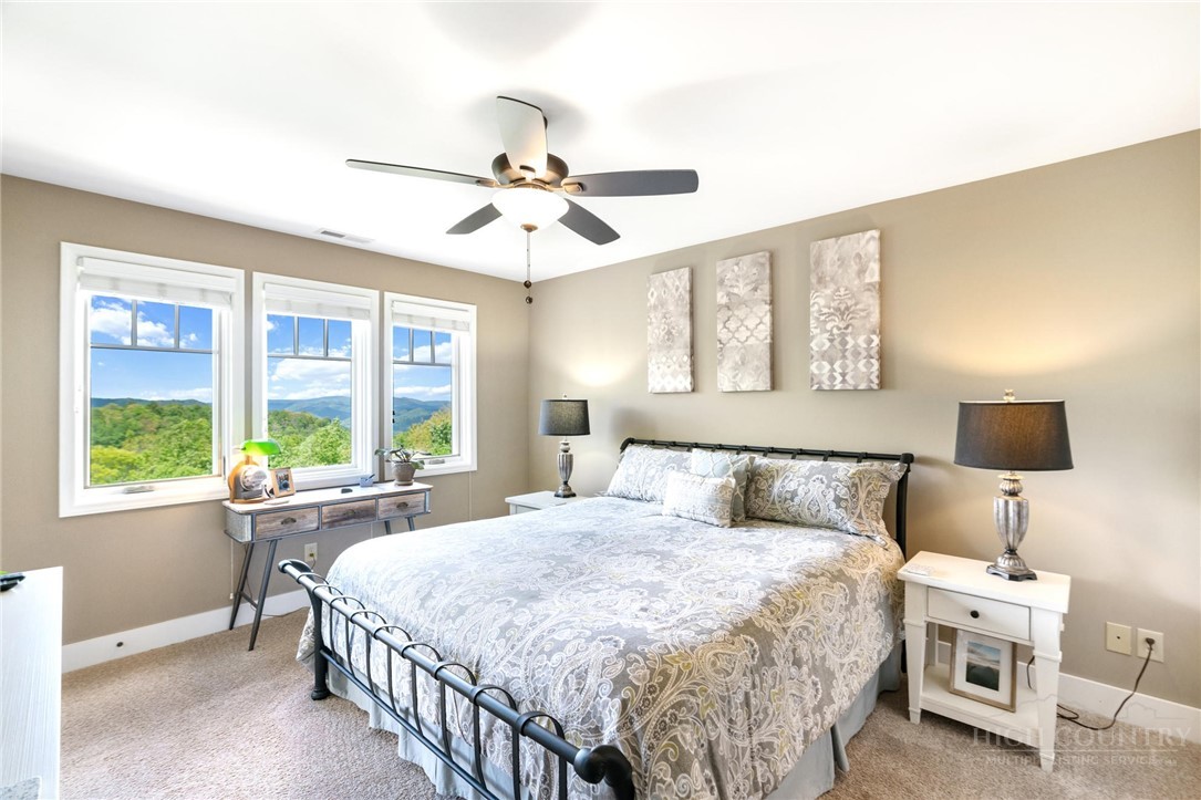 942 Ridge Haven Parkway, Unit R1211 Banner Elk, NC 28604 - Photo 19 of 45 a bedroom with a large bed and a window