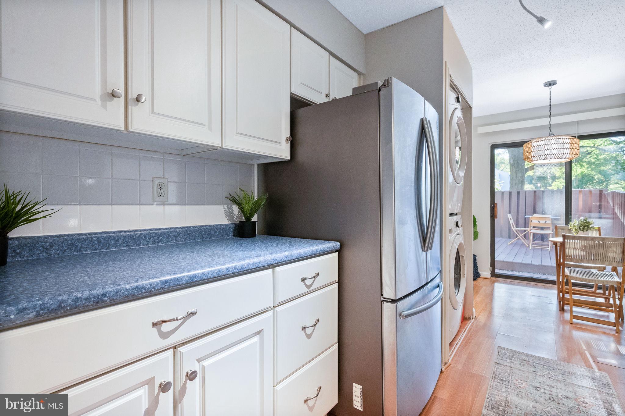 2340 Southgate Square Reston, VA 20191 - Photo 12 of 33 a kitchen with stainless steel appliances a refrigerator sink and cabinets
