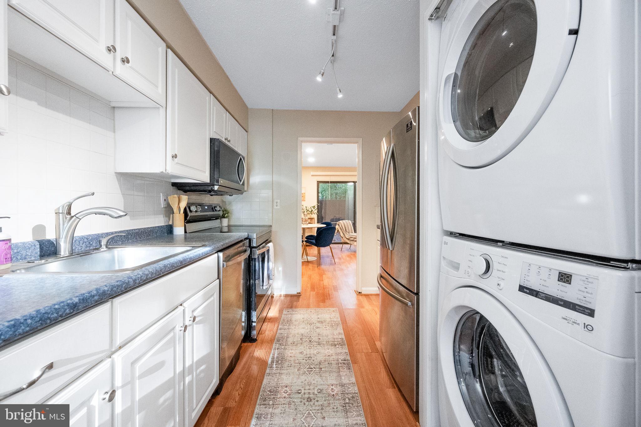 2340 Southgate Square Reston, VA 20191 - Photo 14 of 33 a kitchen with stainless steel appliances granite countertop a sink a stove and a refrigerator