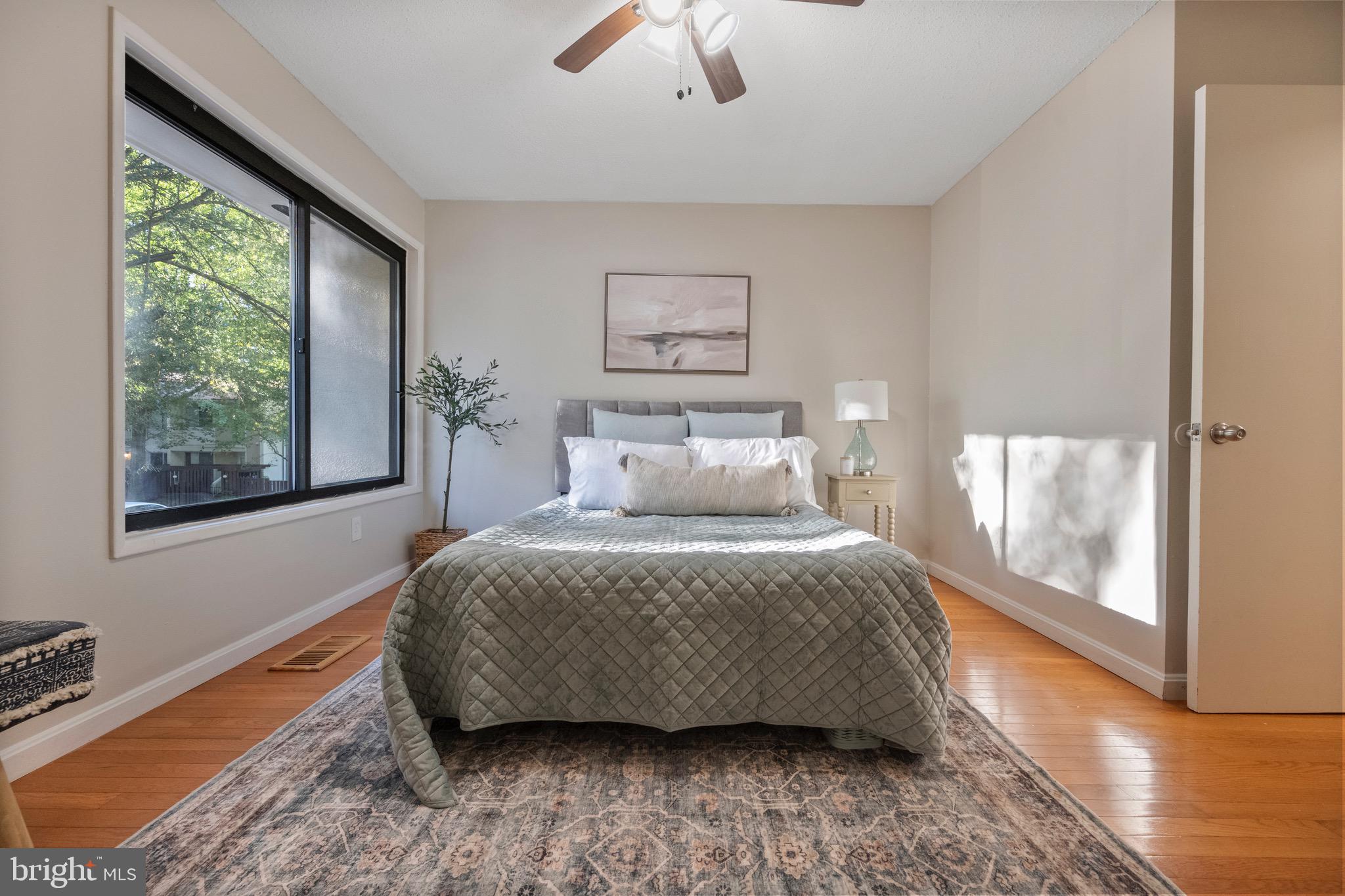 2340 Southgate Square Reston, VA 20191 - Photo 24 of 33 a bedroom with a bed and wooden floor