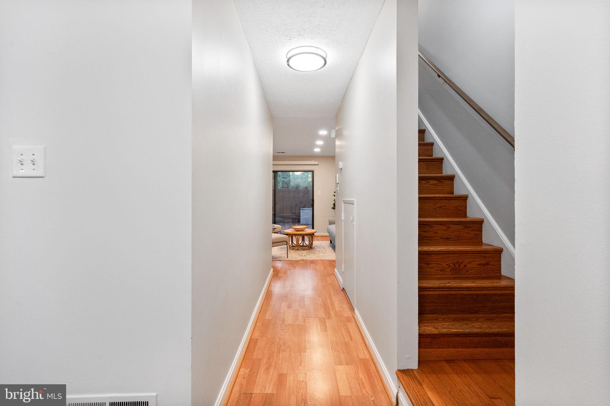 2340 Southgate Square Reston, VA 20191 - Photo 10 of 33 a view of a hallway with wooden floor and staircase