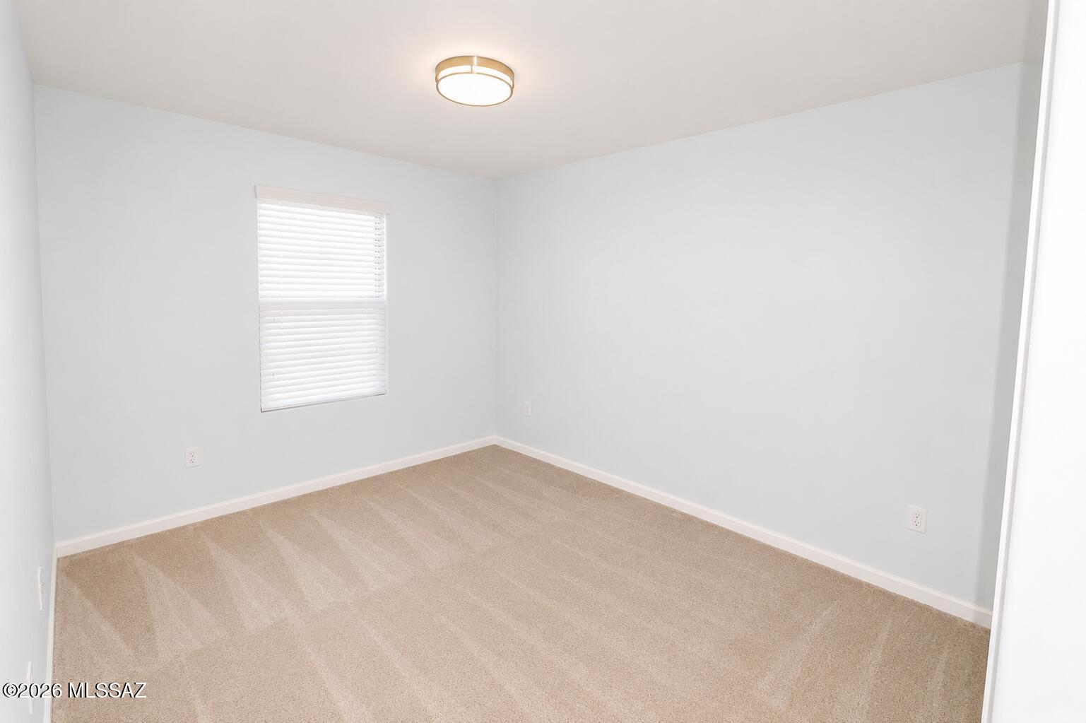 11484 East Desert Raptor Loop Tucson, AZ 85747 - Photo 16 of 28 an empty room with a window