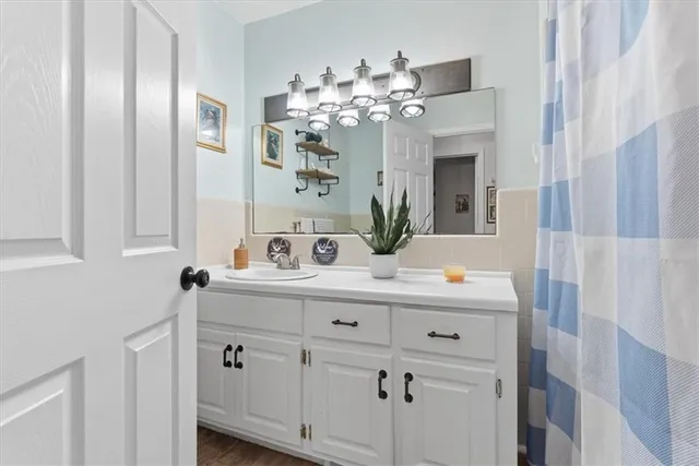 a bathroom with a sink vanity and mirror