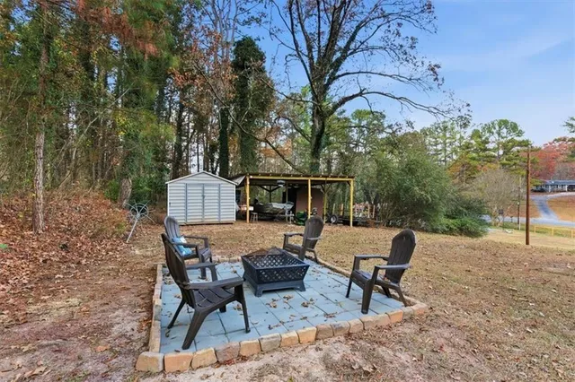 a view of a backyard with sitting area