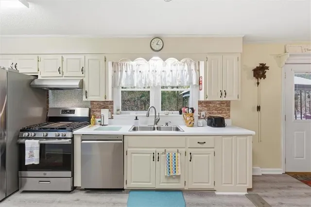 a kitchen with kitchen island white cabinets and white appliances