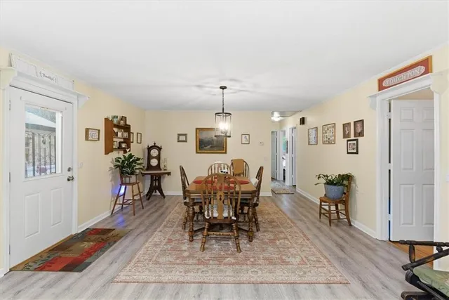 a dining room with wooden floor and breakfast area