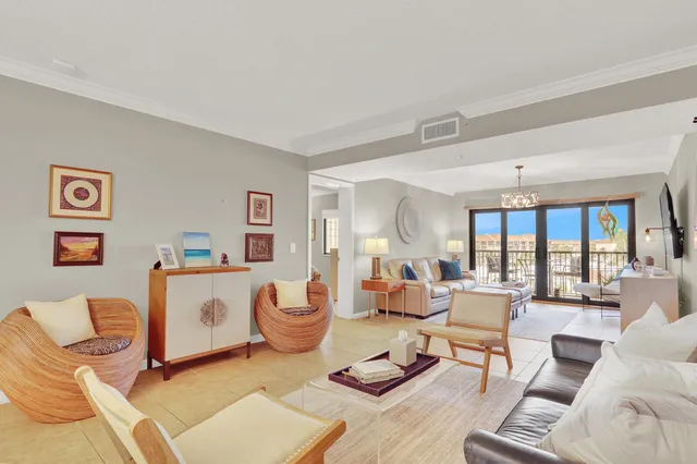 a living room with furniture a flat screen tv and a large window