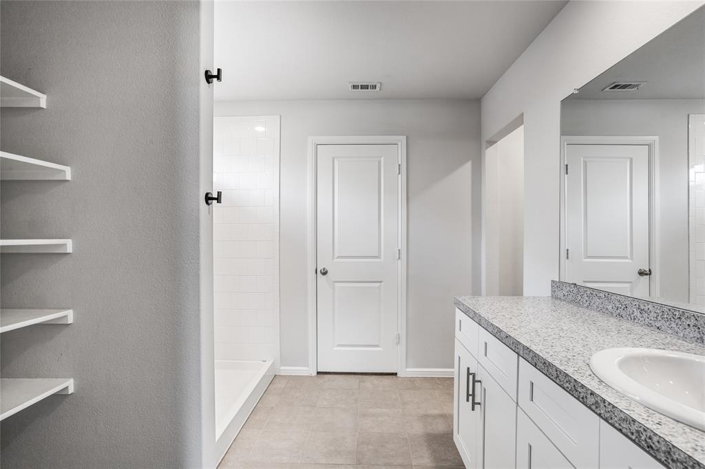 424 Amory Street Azle, TX 76020 - Photo 16 of 27 a bathroom with a granite countertop sink and a mirror