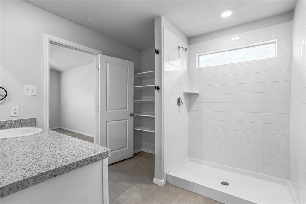 424 Amory Street Azle, TX 76020 - Photo 17 of 27 a bathroom with a granite countertop sink and shower