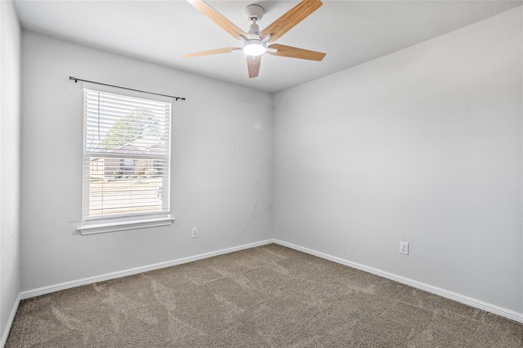 424 Amory Street Azle, TX 76020 - Photo 24 of 27 an empty room with a window and a fan