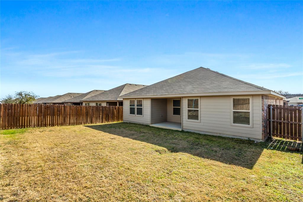 424 Amory Street Azle, TX 76020 - Photo 4 of 27 a front view of a house with a yard