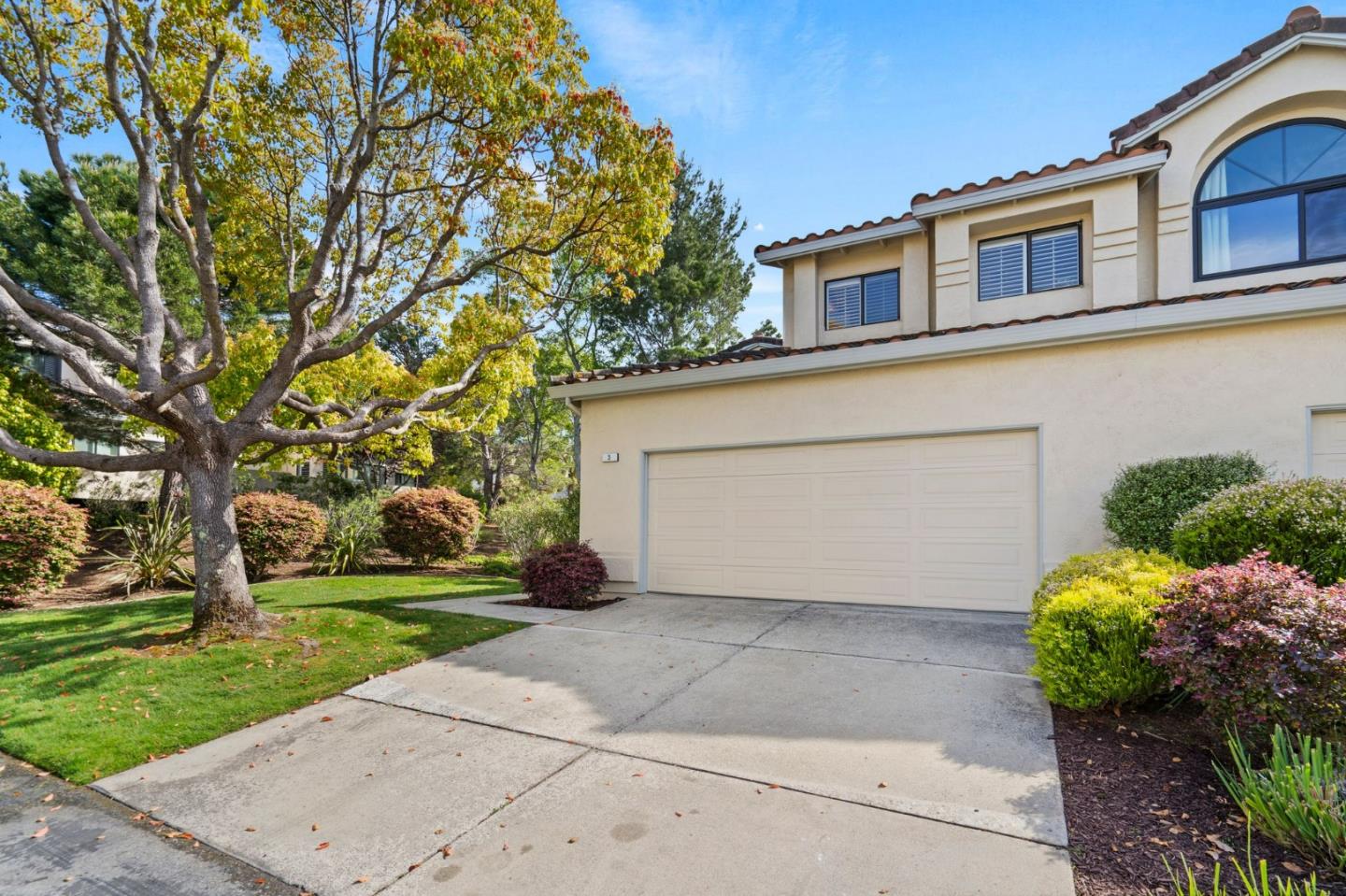 a front view of a house with a yard and a garage