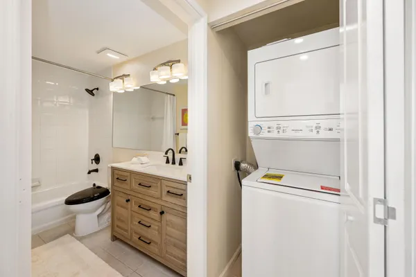 a bathroom with a granite countertop sink a toilet and a mirror