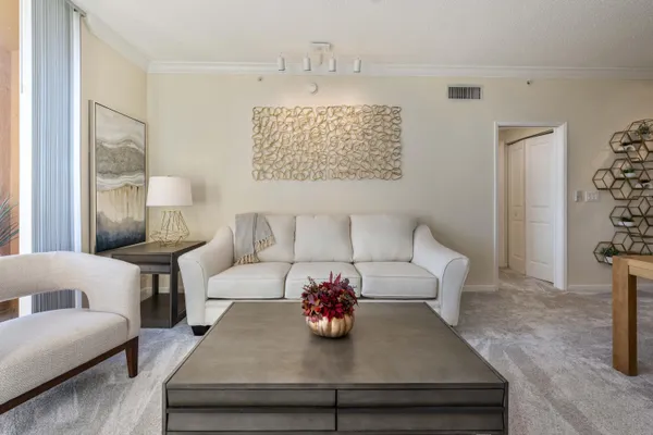 a living room with furniture and a chandelier